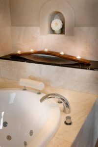 A bath with candles at the end