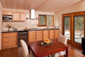 Beautiful handmade table with custom wood kitchen behind.