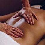Hands on a bare back