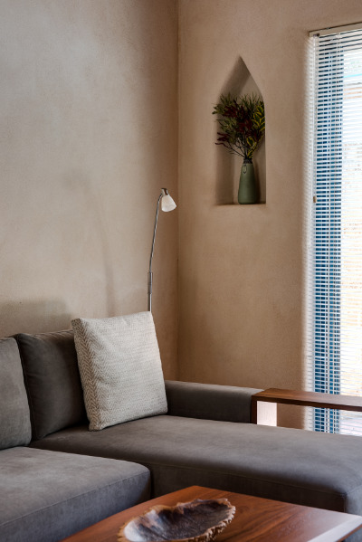 A corner lounge suite with wooden table in soft light
