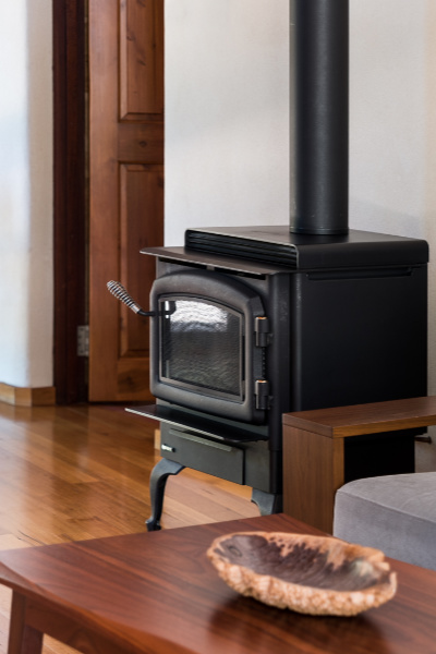 A slow combustion fireplace on a wooden floor